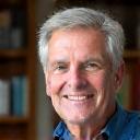 Portrait of David R., a smiling man in his late 50s.